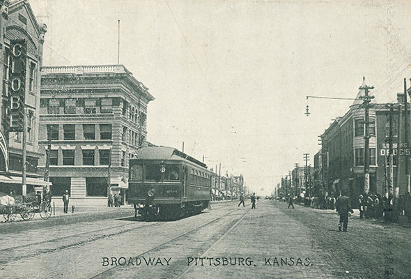 An old photo shows a street car traversing past 4th and Broadway in Pittsburg, Kansas.