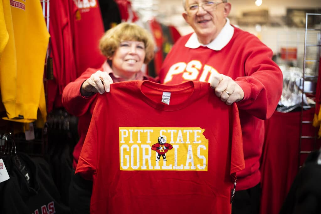 Business owners holding a shirt