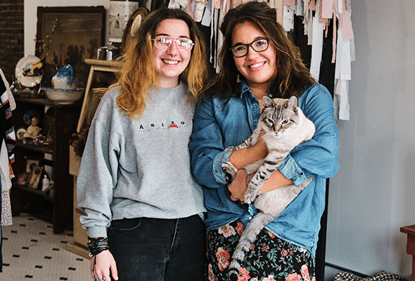 two women holding cat